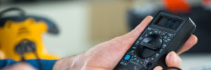 Hand holding a multimeter